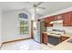 Bright kitchen featuring tile floors, stainless steel refrigerator, and cherry cabinets at 271 Morning Glory Dr, Lake Mary, FL 32746