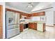 Functional kitchen featuring stainless steel appliances, cherry cabinets, and tile flooring at 271 Morning Glory Dr, Lake Mary, FL 32746