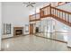 Spacious living room features a brick fireplace, tile flooring, and staircase to the second story at 271 Morning Glory Dr, Lake Mary, FL 32746