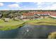 Overhead view of golf course clubhouse and community amenities next to a scenic lake at 2710 Bolzano Dr, Apopka, FL 32712