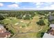Aerial view of golf course, with well-manicured greens, mature trees, and residential development at 2710 Bolzano Dr, Apopka, FL 32712