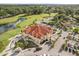 Stunning aerial view of a clubhouse overlooking the golf course, pond and parking at 2710 Bolzano Dr, Apopka, FL 32712
