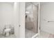Tiled bathroom with a toilet and glass-enclosed shower, providing a clean and functional space at 2710 Bolzano Dr, Apopka, FL 32712