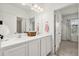 Bathroom featuring double sinks, white cabinets, modern fixtures, and a well-lit vanity area at 2710 Bolzano Dr, Apopka, FL 32712