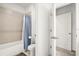 Compact bathroom showcasing a toilet, shower with a curtain, and clean, tiled walls at 2710 Bolzano Dr, Apopka, FL 32712