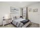 Cozy bedroom with a striped bedspread, wooden accents, decorative pillows, and large wall art at 2710 Bolzano Dr, Apopka, FL 32712