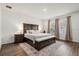 Spacious bedroom with a large bed, an accent rug, and a window providing ample natural light at 2710 Bolzano Dr, Apopka, FL 32712