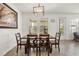 Dining area featuring a wooden table, chairs, and a stylish chandelier at 2710 Bolzano Dr, Apopka, FL 32712