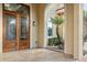 Grand entrance featuring double doors, detailed stonework, and lush landscaping at 2710 Bolzano Dr, Apopka, FL 32712