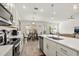Open-concept kitchen featuring an island, stainless steel appliances, and a seamless flow to the dining area at 2710 Bolzano Dr, Apopka, FL 32712