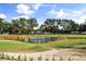 Scenic pond with a fountain, surrounded by lush greenery and mature trees in a serene setting at 2710 Bolzano Dr, Apopka, FL 32712