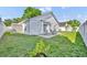 Backyard featuring a patio, green grass and a white privacy fence with mature trees at 280 Bay St, Apopka, FL 32712