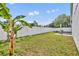 A beautifully landscaped backyard with well maintained lawn, privacy fence and patio area at 280 Bay St, Apopka, FL 32712