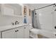 Bathroom featuring a white vanity, brushed black fixtures, framed mirror, and a shower-tub combo at 280 Bay St, Apopka, FL 32712