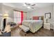 Cozy bedroom features a ceiling fan, and neutral decor with hardwood floors and a large window at 280 Bay St, Apopka, FL 32712