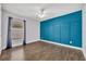 Bedroom with wood flooring, and a large window with curtain and a unique accent wall at 280 Bay St, Apopka, FL 32712