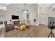 Open living room with vaulted ceilings, wood floors, and stylish furnishings at 280 Bay St, Apopka, FL 32712