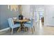 Cozy dining area with a round table, upholstered chairs, and elegant décor at 2903 Canary Ave, Davenport, FL 33837