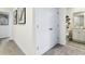 Hallway with neutral carpet leads to a stylish bathroom and features modern artwork at 2903 Canary Ave, Davenport, FL 33837