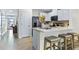 Open-concept kitchen with stainless steel appliances, white cabinets and island seating at 2903 Canary Ave, Davenport, FL 33837
