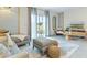 Bright living room with comfortable seating, stylish rug, and backyard views from the sliding glass doors at 2903 Canary Ave, Davenport, FL 33837