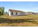 View of backyard showing the home's exterior with multiple windows offering plenty of natural light at 3166 Canby Dr, Deltona, FL 32738