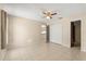 Neutral bedroom features tile flooring, a ceiling fan, and closet with double doors at 3166 Canby Dr, Deltona, FL 32738