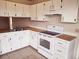 Functional kitchen with white cabinetry, laminate countertops, and essential appliances at 3166 Canby Dr, Deltona, FL 32738