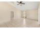Open living room area featuring neutral walls, tile flooring, and a ceiling fan at 3166 Canby Dr, Deltona, FL 32738