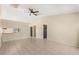 Spacious open-concept living room with neutral colors and tiled flooring, seamlessly connecting to other living areas at 3166 Canby Dr, Deltona, FL 32738