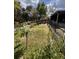 Fenced backyard featuring a garden area with young trees and plenty of space for outdoor activities at 3219 Chariot Pl, Orlando, FL 32818