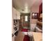 Bathroom featuring tiled shower, red accent wall, white storage cabinet, and toilet at 3219 Chariot Pl, Orlando, FL 32818