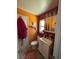Compact bathroom featuring colorful walls, a vanity with storage, and a window for natural light at 3219 Chariot Pl, Orlando, FL 32818