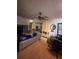 Bedroom features a large bed with mirrored storage unit, wood flooring, and desk at 3219 Chariot Pl, Orlando, FL 32818