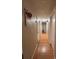Hallway with laminate wood flooring, neutral walls, and closet doors at 3219 Chariot Pl, Orlando, FL 32818