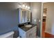Bathroom featuring granite countertops, sleek vanity mirror, and modern sink at 3220 Cardigan Ct, Orlando, FL 32812