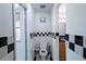 Bathroom featuring black and white checkered accents, toilet, and small window at 3220 Cardigan Ct, Orlando, FL 32812