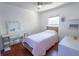 Bright bedroom features a ceiling fan, wood floors, and vanity makeup station at 3220 Cardigan Ct, Orlando, FL 32812