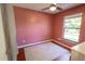 Bedroom featuring a ceiling fan, window, wood floor, and a large area rug at 3220 Cardigan Ct, Orlando, FL 32812