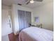 Bedroom with wood floors, modern ceiling fan, and large window at 3220 Cardigan Ct, Orlando, FL 32812