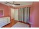 Bedroom with a ceiling fan, window, wood floor, and door to the hallway at 3220 Cardigan Ct, Orlando, FL 32812