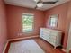 Bedroom with a ceiling fan, wood floors, a window, and dresser at 3220 Cardigan Ct, Orlando, FL 32812