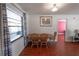 Bright dining area with hardwood floors, natural light, and space for a Gathering-sized table at 3220 Cardigan Ct, Orlando, FL 32812