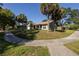 Charming home with mature trees, a cozy front porch, and a well-maintained lawn at 3220 Cardigan Ct, Orlando, FL 32812
