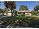 Charming single-story home featuring tropical landscaping, stone accents, and an attached two-car garage at 3220 Cardigan Ct, Orlando, FL 32812