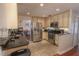 Spacious kitchen featuring stainless steel appliances, black countertops and a seamless flow to the dining area at 3220 Cardigan Ct, Orlando, FL 32812