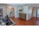 Open-concept living room with wood floors, neutral walls, and plenty of natural light at 3220 Cardigan Ct, Orlando, FL 32812