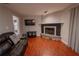 Living room featuring a fireplace, hardwood floors, and comfortable seating for cozy gatherings at 3220 Cardigan Ct, Orlando, FL 32812