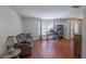 Comfortable living room featuring hardwood floors, a gray sofa, and natural light at 3220 Cardigan Ct, Orlando, FL 32812