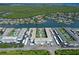 Overhead shot of a waterfront condominium complex with pools, carports, and lush surroundings on the coast at 325 N Causeway # D-206, New Smyrna Beach, FL 32169